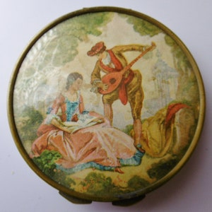 Vintage French brass compact with Romantic scene.