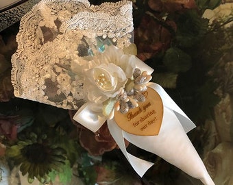 May include: White lace cone with a white satin ribbon and a wooden heart-shaped tag that says "Thank you for sharing our day!"
