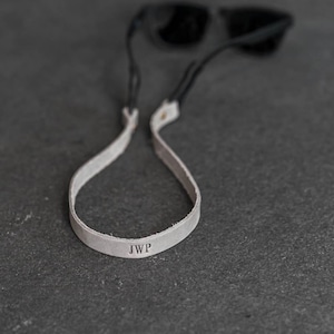 May include: A set of three ceramic mugs with a speckled, matte finish. The mugs are in shades of cream, light brown, and dark brown. Each mug has a simple, minimalist design, perfect for coffee or tea.