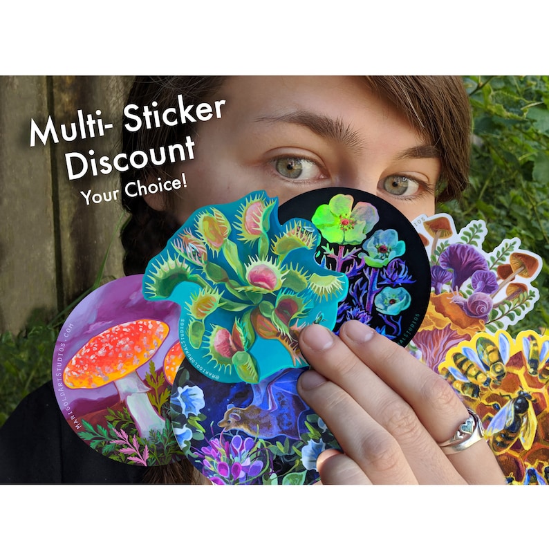 May include: A collection of colorful stickers featuring botanical and nature-themed designs, including a Venus flytrap, mushrooms, and bees. The stickers are held in front of a person's face, with the text "Multi-Sticker Discount Your Choice!" visible.