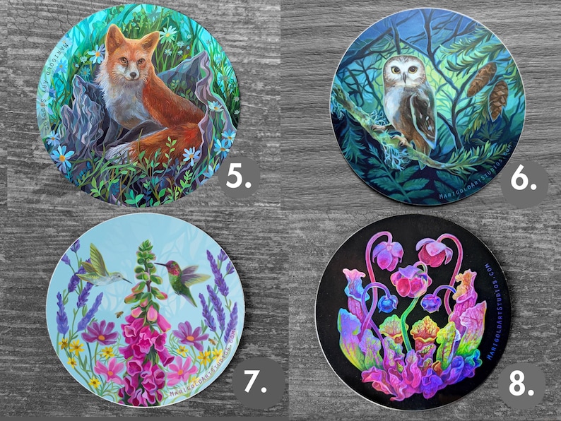 May include: Set of four round stickers featuring nature-themed illustrations. Includes a fox in a forest, an owl on a branch, hummingbirds and flowers, and colorful, abstract plants. Each sticker has the artist's name printed on it.