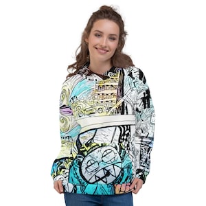 May include: A colorful hoodie with a unique, artistic design. The graphic features a cartoonish face with sharp teeth, set against a backdrop of swirling lines, buildings, and vehicles. The color palette includes blue, yellow, and black.