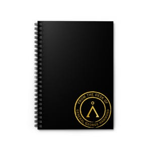 May include: Black spiral notebook with a gold foil sticker that says "From the Desk of General George Hammond" and features the Stargate Command symbol.