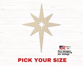 May include: A light-colored wooden star cutout with eight points of varying lengths and a small star-shaped negative space in the center. The text below reads PICK YOUR SIZE, and a small graphic includes the text Made in USA See images for sizing!