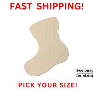May include: A wooden cutout of a Christmas stocking in the shape of a boot. The stocking is light brown and has a smooth surface.  "Pick Your Size!" and "See images for sizing!" are written in black text below the stocking.