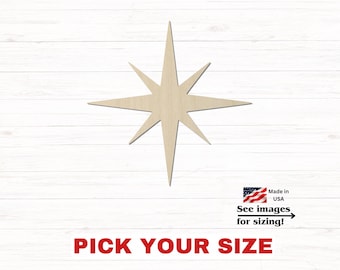 May include: A light-colored wooden star cutout with eight points of varying lengths. The design features a central point with four long rays and four shorter rays. Below the star, text reads Made in USA, See images for sizing!, and PICK YOUR SIZE.