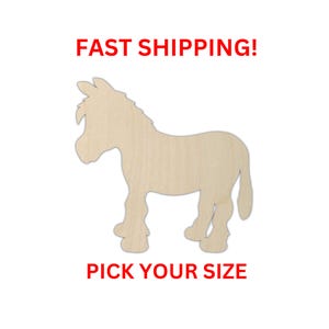May include: A light-colored wooden cutout in the shape of a donkey standing in profile. The donkey has a textured mane and tail with visible wood grain. The text FAST SHIPPING! appears above the donkey and PICK YOUR SIZE appears below it.