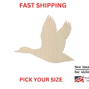 May include: A light-colored wooden cutout in the shape of a flying duck. The image includes red text that reads FAST SHIPPING and PICK YOUR SIZE, along with black text that reads See images for sizing! and Made in USA with a small American flag icon.