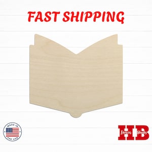 May include: A light-colored, unfinished wooden cutout shaped like an open book with a V-shaped top edge and a small rounded tab at the bottom center. The surface shows natural wood grain patterns and a smooth, flat texture throughout the piece.