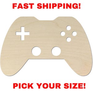 May include: A light-colored wooden cutout shaped like a video game controller with a plus-shaped directional pad, four circular button holes, and two larger circular holes at the bottom. The text FAST SHIPPING! appears above and PICK YOUR SIZE! below.