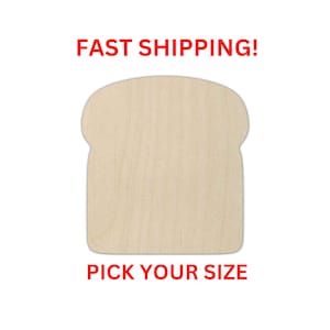 May include: A light-colored, flat wooden cutout shaped like a slice of bread with a rounded top and a square base. The surface displays a natural wood grain pattern with a smooth, unfinished texture. The object is presented as a blank shape.