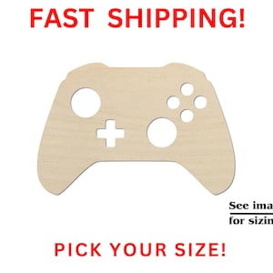 May include: A light-colored wooden cutout in the shape of a video game controller with circular and cross-shaped cutouts. The text FAST SHIPPING! is at the top, PICK YOUR SIZE! is at the bottom, and See images for sizing! with an arrow is included.