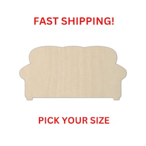 May include: A light-colored, unfinished wooden cutout in the shape of a sofa with rounded back cushions and armrests. The cutout features a smooth, flat surface with visible wood grain patterns, presented as a blank template for crafting projects.