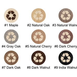 May include: Nine different wood veneer samples with a laser-engraved recycle symbol. The wood types are Maple, Natural Oak, Natural Walnut, Gray Oak, Natural Cherry, Dark Cherry, Dark Oak, Dark Walnut, and India Walnut.