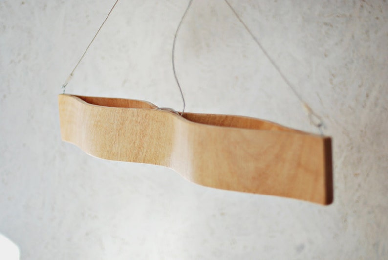 hanging lamp made from bent plywood. The Eyes