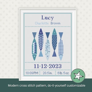 May include: A cross stitch pattern featuring a blue and white fish design with the text "Lucy Charlotte Brown" and "11-12-2023 10:09 PM 20.5 in. 6 lb. 5 oz."