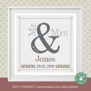 May include: A customizable cross stitch pattern with the text "Mr. & Mrs. Jones 28.02.2019" in a gray and white color scheme.