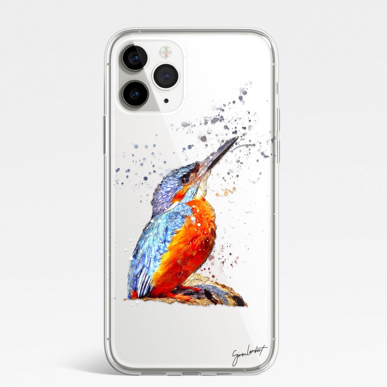 May include: Clear iPhone case featuring a watercolor painting of a kingfisher bird. The bird has blue, orange, and white feathers, with a long beak. The case has a glossy finish and a signature in the bottom right corner.