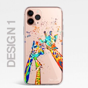 May include: A clear phone case with a colorful watercolor design of three giraffes. The giraffes are painted in shades of blue, green, yellow, orange, and red. The case has a gold background and the artist's signature is visible in the bottom right corner.