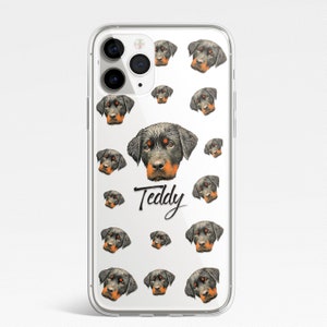 May include: Clear phone case with a repeating pattern of Rottweiler dog faces. The text "Teddy" is printed in black cursive on the case.