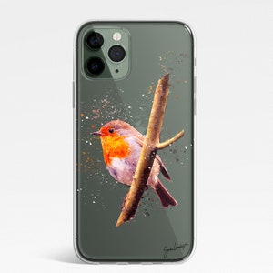 May include: Clear phone case featuring a watercolor painting of a robin perched on a branch. The bird has a vibrant orange breast and is set against a muted green background with paint splatter details. The case has a glossy finish.