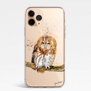 May include: Clear phone case featuring a watercolor painting of a brown and white owl perched on a branch. The owl has closed eyes and is set against a beige background with paint splatters. The artist's signature is visible.