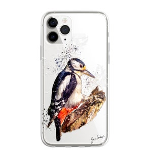 May include: Clear phone case featuring a watercolor painting of a woodpecker perched on a branch. The bird has black, white, red, and yellow markings. The case has a glossy finish and a signature in the bottom right corner.