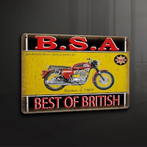 May include: A vintage-style metal sign with a yellow background and black lettering. The sign features a red motorcycle with the text "BSA Birmingham Small Arms Company Ltd. Rocket 3 1969 Best of British".