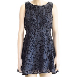 May include: A black sleeveless dress with a floral pattern. The dress has a fitted bodice and a flared skirt.
