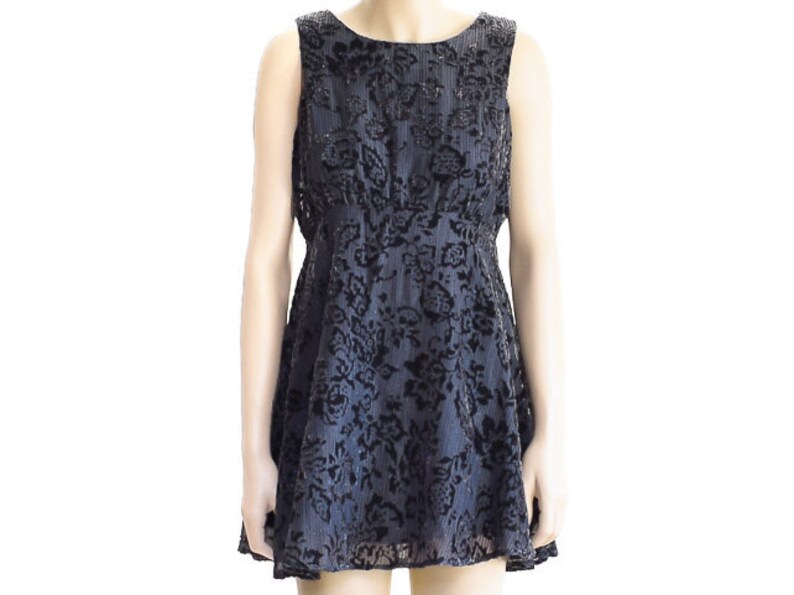 May include: A black sleeveless dress with a floral pattern. The dress has a fitted bodice and a flared skirt.