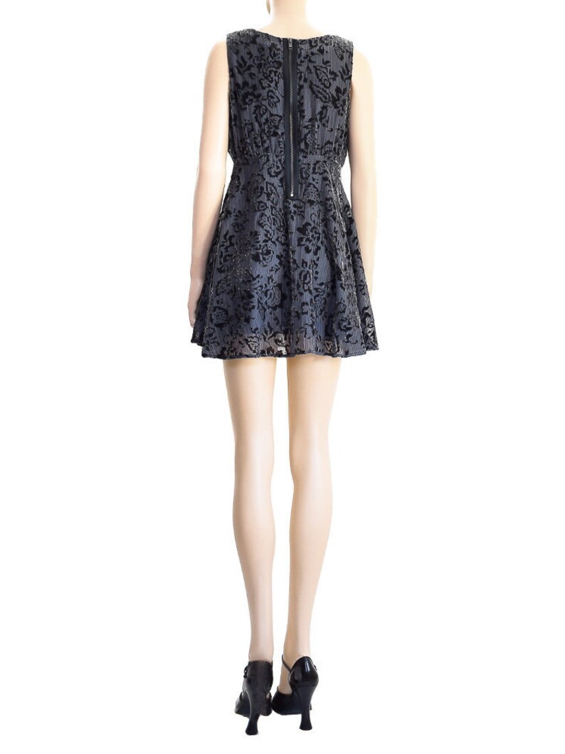 May include: A black and gray sleeveless dress with a floral pattern. The dress has a fitted bodice and a flared skirt. The dress is shown on a mannequin.