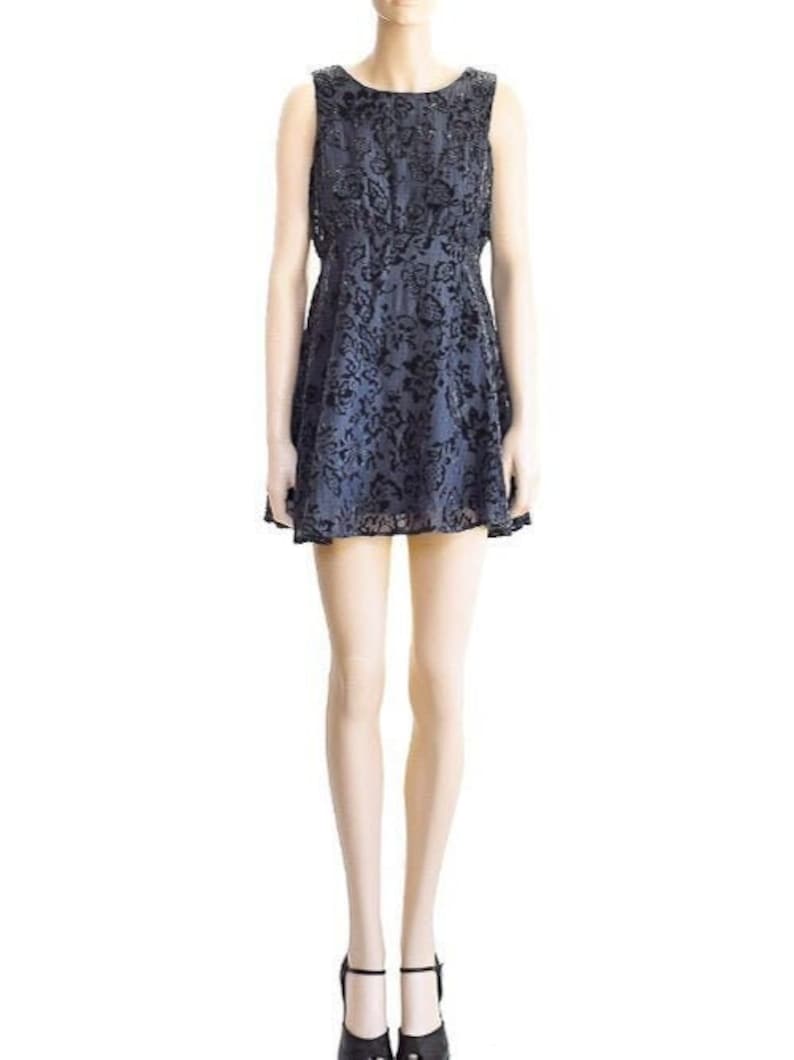 May include: A sleeveless, knee-length, black and gray floral print dress with a fitted bodice and a flared skirt.