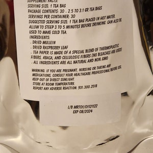 May include: White label with black text listing supplement facts for a tea bag. The label includes serving size, package contents, servings per container, suggested serving size, ingredients, and a warning. The label also includes the lot number and expiry date: L/B MRT01/01121122 EXP 08/2024.
