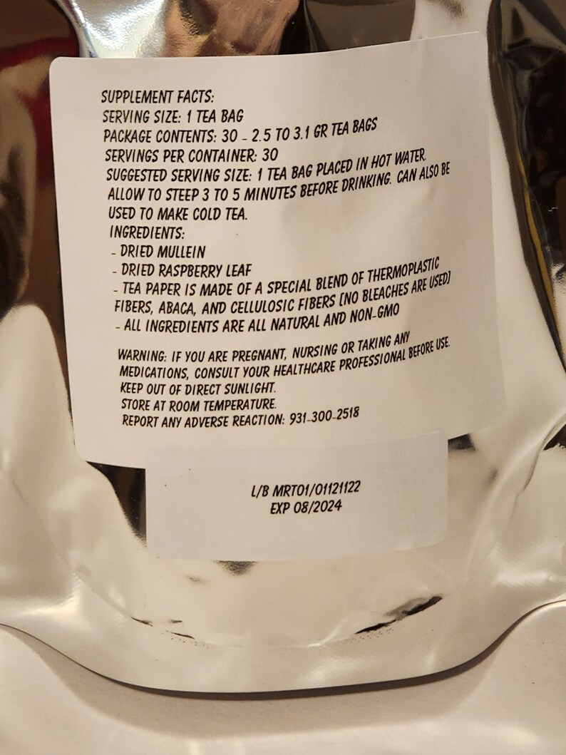 May include: White label with black text listing supplement facts for a tea bag. The label includes serving size, package contents, servings per container, suggested serving size, ingredients, and a warning. The label also includes the lot number and expiry date: L/B MRT01/01121122 EXP 08/2024.