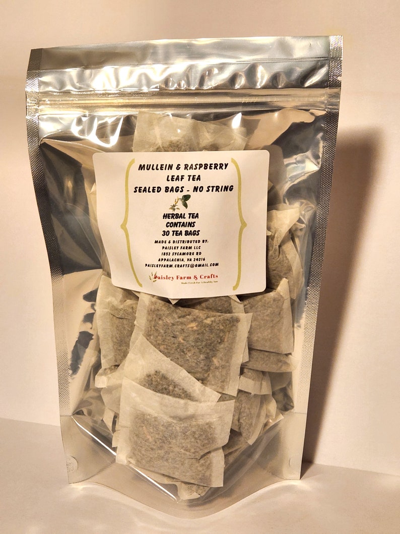 May include: A silver resealable bag filled with 30 individual tea bags of Mullein & Raspberry Leaf Tea. The tea bags are sealed and have no string. The label reads "Herbal Tea Contains 30 Tea Bags" and "Mullein & Raspberry Leaf Tea Sealed Bags - No String".