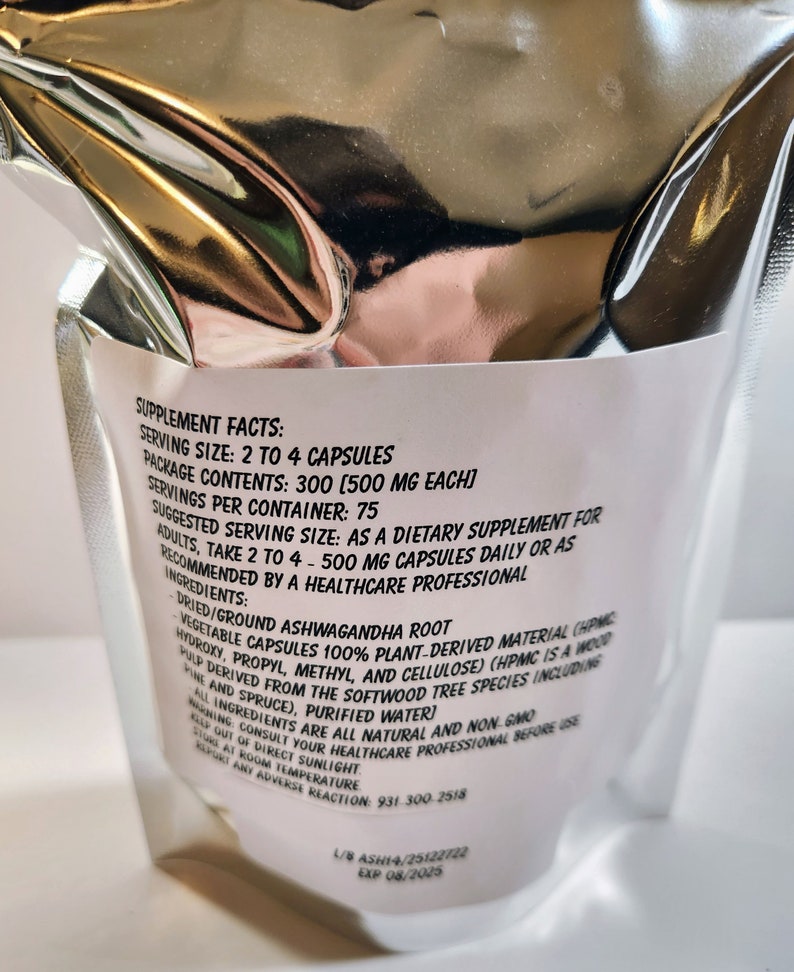 May include: White bag with black text listing supplement facts for Ashwagandha root capsules. Serving size is 2 to 4 capsules, package contains 300 capsules, 500 mg each. Suggested serving size is 2 to 4 capsules daily or as recommended by a healthcare professional. Ingredients include dried/ground Ashwagandha root, vegetable capsules 100% plant-derived material, purified water.
