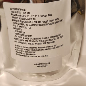 May include: White tea bag package with supplement facts and ingredients listed. The tea bag contains 20 - 2.5 to 3.1 grams of tea. The ingredients include dried mullein, dried raspberry leaf, and a special blend of thermoplastic fibres, abaca, and cellulosic fibres. The package also includes a warning for pregnant, nursing, or taking any medications. The package has a lot number and expiry date.