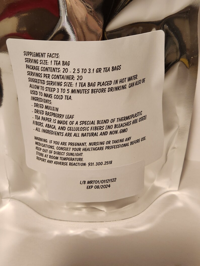 May include: White tea bag package with supplement facts and ingredients listed. The tea bag contains 20 - 2.5 to 3.1 grams of tea. The ingredients include dried mullein, dried raspberry leaf, and a special blend of thermoplastic fibres, abaca, and cellulosic fibres. The package also includes a warning for pregnant, nursing, or taking any medications. The package has a lot number and expiry date.