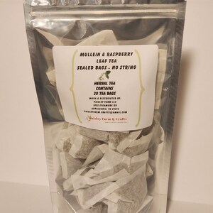 May include: A clear plastic bag filled with 20 individual tea bags containing a blend of mullein and raspberry leaf tea. The label reads "Mullein & Raspberry Leaf Tea, Sealed Bags - No String, Herbal Tea Contains 20 Tea Bags, Made & Distributed by Paisley Farm LLC, 1852 Sycamore Rd, Appalachia, VA 24216, Paisleyfarm.Crafts@gmail.com, Paisley Farm & Crafts".