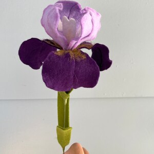 May include: A felt purple and lavender iris flower with a green stem.