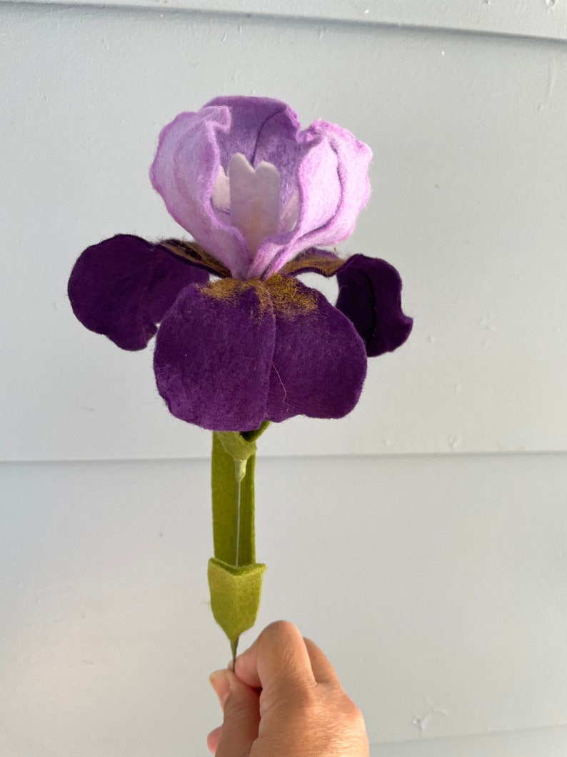 May include: A felt purple and lavender iris flower with a green stem.
