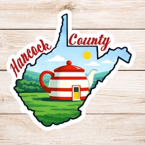 May include: A sticker featuring the outline of West Virginia with the words "Hancock County" in red script. Inside the outline is a teapot with red and white stripes, a yellow door, and a green landscape.