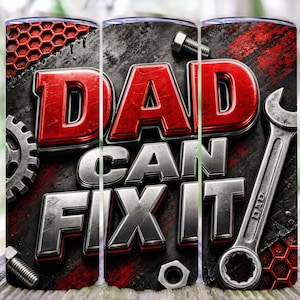 Op de afbeelding: Een tumbler met de tekst "DAD CAN FIX IT" in rood en zilver, tegen een achtergrond van gereedschap en een rood honingraatpatroon. Het ontwerp bevat een sleutel, bouten en tandwielen.