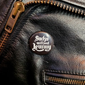 Abernathy&#39;s Sucks Without Lemmy Kilmister Motorhead Heavy Metal Gothic Font Pinback Button