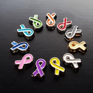 May include: A circle of 10 small silver charms in the shape of awareness ribbons. The ribbons are in various colors including red, blue, green, yellow, purple, pink, and white.
