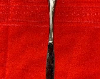 May include: A silver dinner knife with an ornate handle.