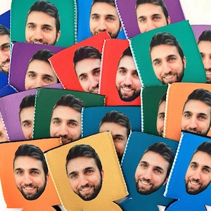 May include: A collection of colorful beverage coolers with different faces printed on them. The coolers are made of foam and have a zipper closure.