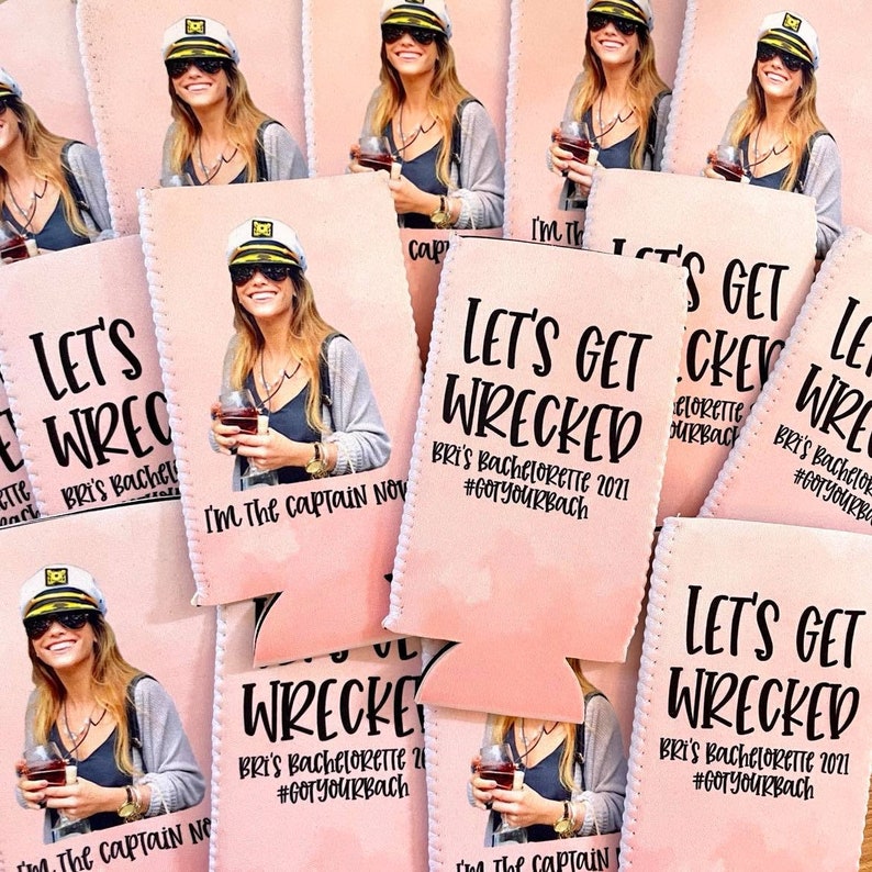 May include: Pink and white can coolers with the text "Let's Get Wrecked" and "Bri's Bachelorette 2021 #GotYourBach". The can coolers feature a photo of a woman wearing a captain's hat and holding a glass of wine.
