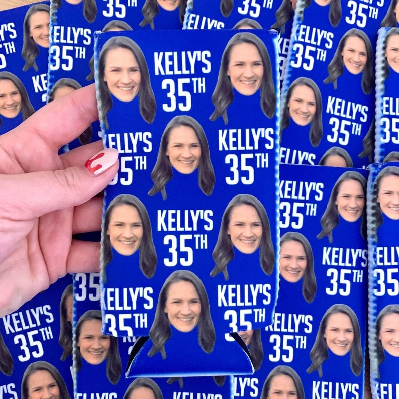 May include: A blue and white can cooler with a repeating pattern of a woman's face and the text "Kelly's 35th".