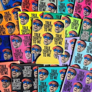 May include: A collection of colorful can coolers with a repeated pattern of a person wearing a red hat and sunglasses. The text "Talk Thirty To Me" is printed on each cooler.